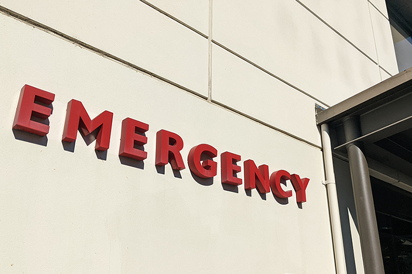 Exterior emergency sign next to emergency room entrance