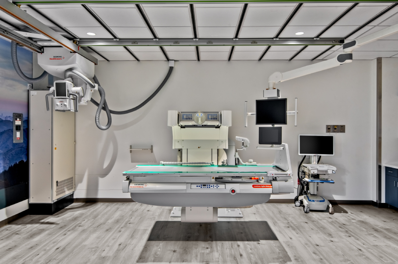 Modern radiation therapy room with linear accelerator and imaging equipment